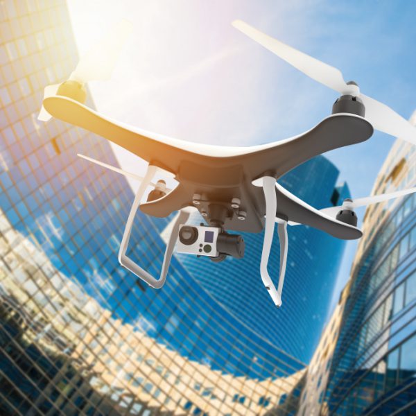 drone-with-digital-camera-flying-modern-city-sunset